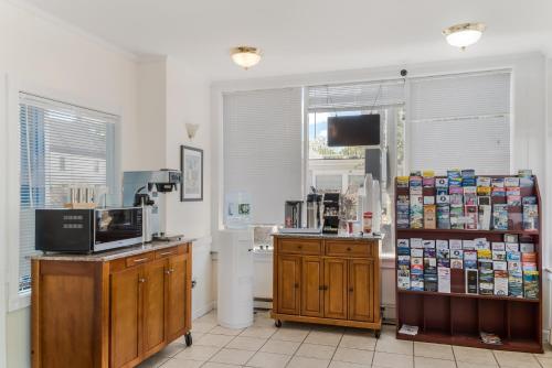 a room with a coffee shop with a counter and a tv at Americas Best Value Inn Hyannis in Hyannis