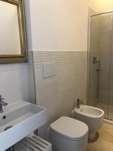 a bathroom with a toilet and a sink and a shower at Belvedere Residenza Mediterranea in Portoferraio