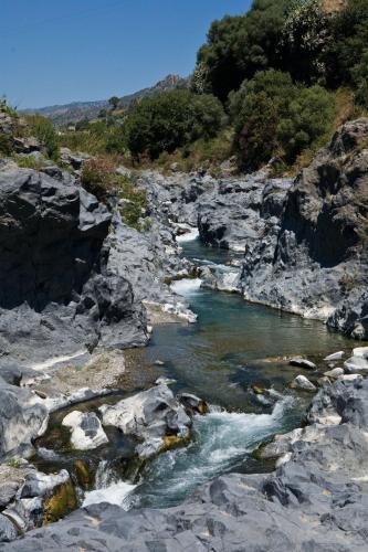 a river with rocks and water in a canyon at Il Poggio Country Resort in Graniti
