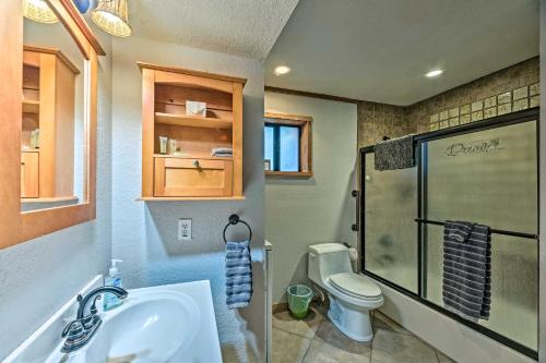 a bathroom with a toilet and a sink and a shower at Ruidoso Cabin with Deck and Grill - Walk to Town! in Ruidoso