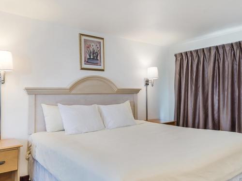a bedroom with a large white bed in a hotel room at Americas Best Value Inn Hyannis in Hyannis