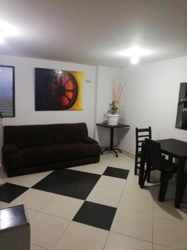 a living room with a couch and a table at HOTEL LA RUEDA SR in Barbosa