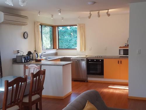 a kitchen with a table and a counter top at Wakari Holiday Home in Dunedin