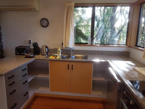 a kitchen with a sink and a counter top at Wakari Holiday Home in Dunedin