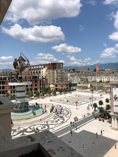 a view of a city with a statue in the foreground at Square Vanilla Apartments in Skopje