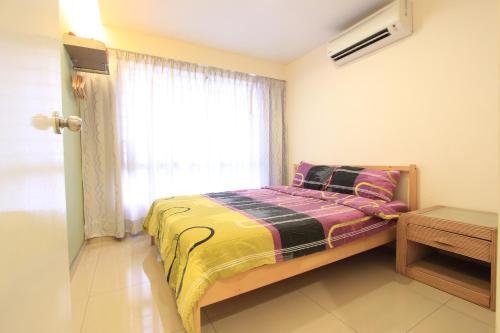 a small bedroom with a bed and a window at Vista Horizon Melaka in Melaka