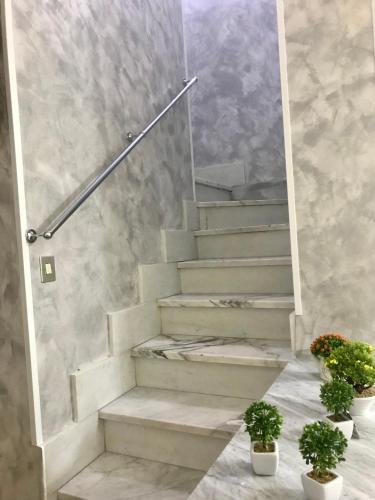 a staircase with two potted plants on the floor at B&B Marrelli Crotone in Crotone
