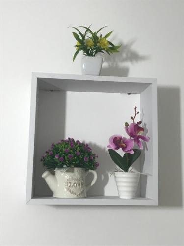 a shelf with two vases and flowers on it at B&B Marrelli Crotone in Crotone