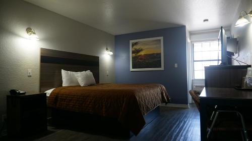 a hotel room with a bed and a desk at La Villita Inn in San Antonio