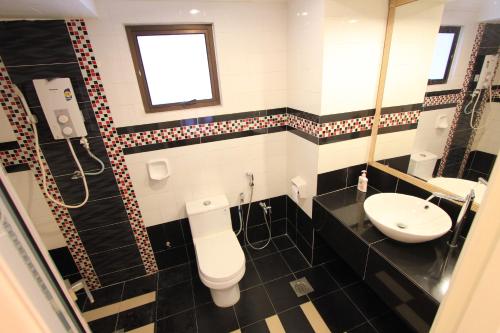 a bathroom with a toilet and a sink at Vista Horizon Melaka in Melaka