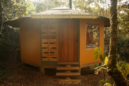 a small cabin in the woods with a tree at Hospedaje Solentiname in Medellín