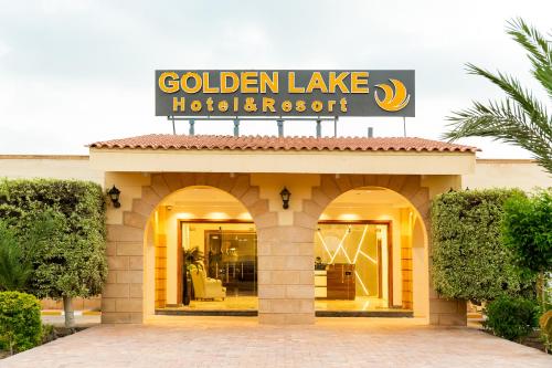 a building with a sign for a golden lake hotel at Golden Lake Marina Hotel in El Alamein