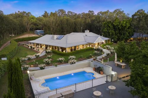 an aerial view of a house with a swimming pool at Thistle Hill Guesthouse - walk to many wineries and restaurants in Pokolbin