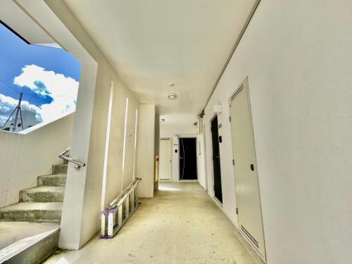 an empty hallway with stairs in a building at Villa Izumizaki in Naha