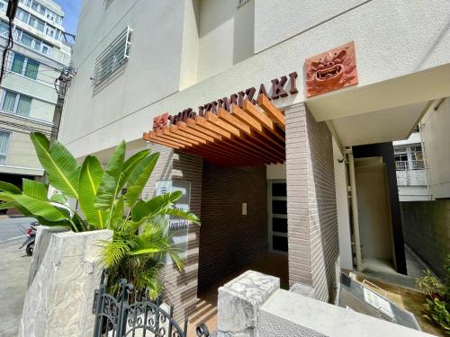 a building with a wooden walkway in front of it at Villa Izumizaki in Naha