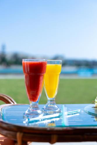 two wine glasses sitting on top of a table at Golden Lake Marina Hotel in El Alamein