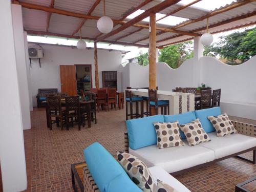 a living room with a couch and tables and chairs at Zurisadai in Puerto Ayora