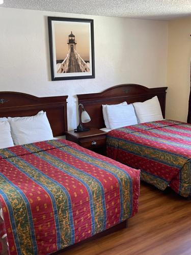 Ένα ή περισσότερα κρεβάτια σε δωμάτιο στο Villa West Motel