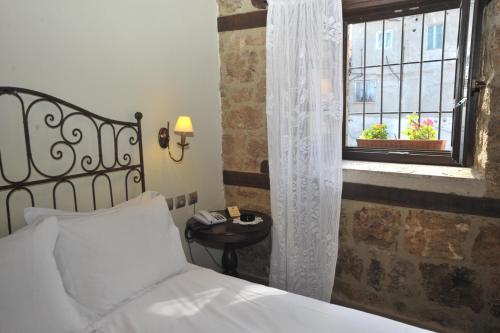 a bedroom with a bed and a window at Varosi 4 Seasons in Edessa
