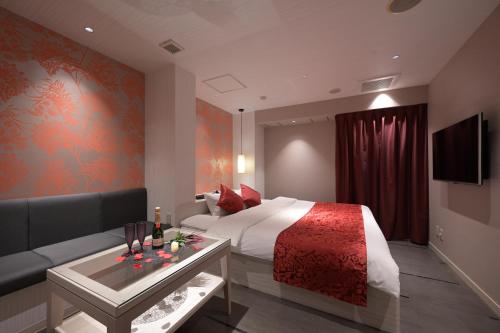 a hotel room with a bed and a couch at BAMBOO GARDEN Shinyokohama only Adult in Yokohama