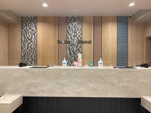 a bathroom with three sinks and a large counter at Smile Hotel Osaka Nakanoshima in Osaka