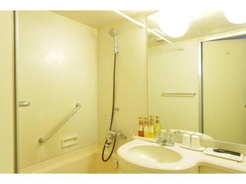 a bathroom with a toilet and a sink and a mirror at Court Hotel Fukuoka Tenjin - Vacation STAY 42330v in Fukuoka