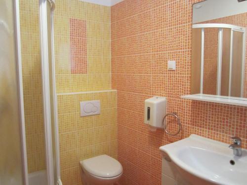 a bathroom with a shower and a toilet and a sink at Guesthouse Punta Mira - Beachfront in Novalja