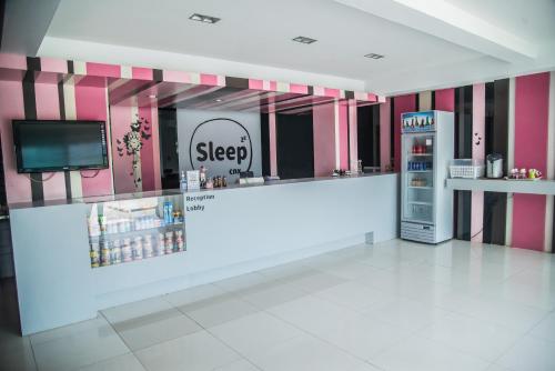 a store with a counter and a refrigerator at Sleep CNX in Chiang Mai