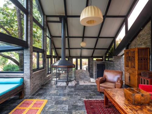 a living room with a fireplace in a house at Brickyard Retreat at Mutianyu Great Wall Adjoin to Mutianyu Great Wall - Room with the View of Great Wall - Chinese massage experience - Vehicle Shuttle Service - International Catering - SPA& Nail Beauty Facilities in Huairou