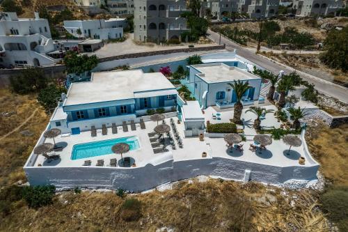 an aerial view of a house with a swimming pool at Ancient Thera Apartments in Kamari