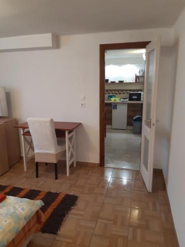 a living room with a table and a dining room at Vendvidék Kapuja Vendégház in Szentgotthárd