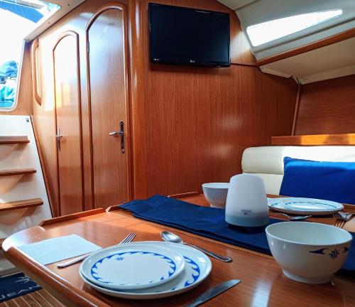 a table with plates and utensils on a boat at Boat House Barcelona in Barcelona