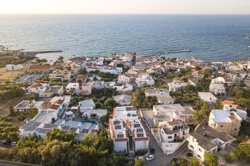 an aerial view of a town next to the ocean at Kasteli Studios & Apartments in Panormos Rethymno