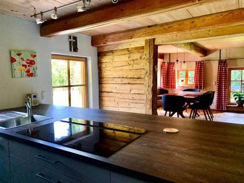 a kitchen with a counter and a dining room at Chalet Dürrfeld ***** in Viechtach