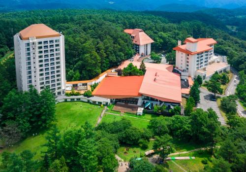 an overhead view of a campus with buildings and trees at Kusatsu Onsen Hotel Village in Kusatsu