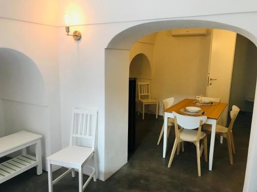 a dining room with a table and chairs at La Grotta di benikula' in Pantelleria