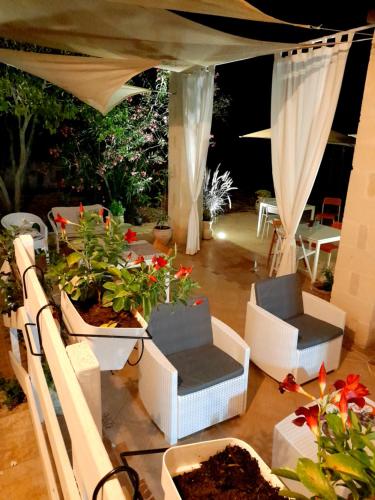 a room with plants and chairs and a tent at Antico Casale Il Sambuco in Manduria