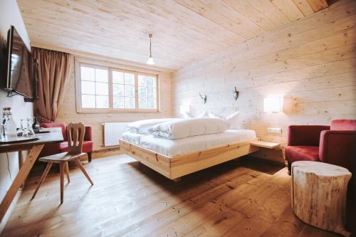 a bedroom with a bed in a wooden room at Hotel Am Fichtelsee in Fichtelberg