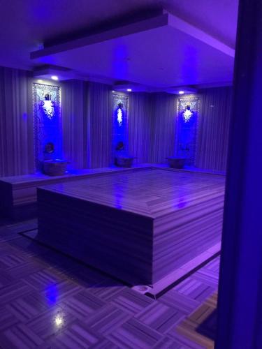 a dance floor with purple lights in a room at Miray Hotel Kleopatra in Alanya
