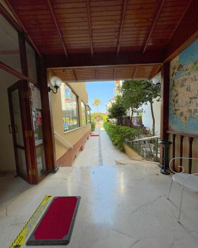 a building with a hallway with a red rug on the floor at Miray Hotel Kleopatra in Alanya