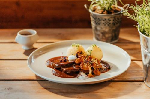 a plate of food on a wooden table at Hotel Am Fichtelsee in Fichtelberg