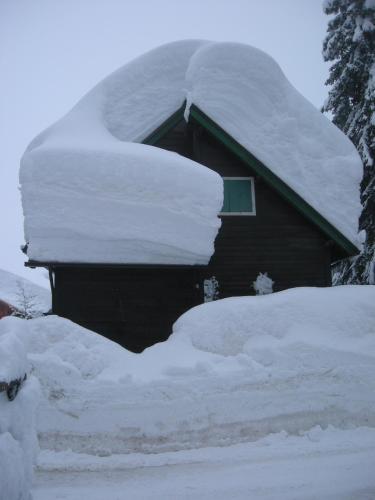 a pile of snow on top of a house at Casa Floriani Fiavè-Comano Terme pink in Fiavè