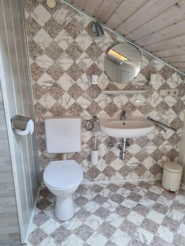 a bathroom with a toilet and a sink at Pension Zollern in Bisingen