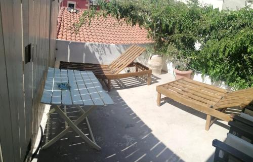 two benches and a table on a patio at "Eirini" traditional house Creta Archanes, Αρχάνες σπίτι in Archanes