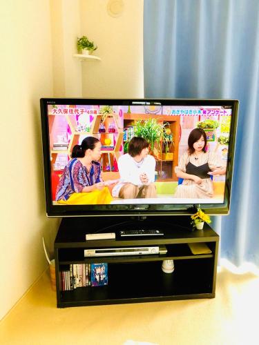 a flat screen tv sitting on a tv stand at Nikko Dream House in Nikko
