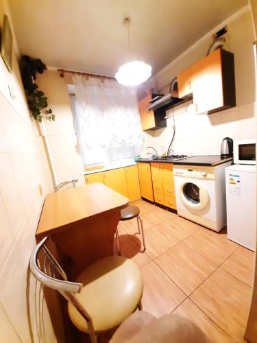 a small kitchen with a table and a microwave at 1 комн кв остановка дворец спорта строитель, рядом с улицей химиков in Cherkasy