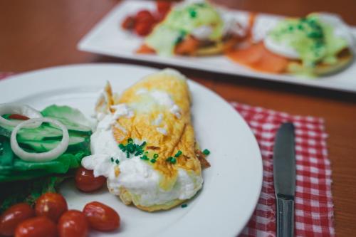 a white plate topped with food on a table at The Smokehouse Hotel & Restaurant Cameron Highlands in Cameron Highlands