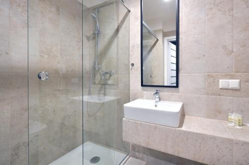 a bathroom with a sink and a glass shower at Lubhotel in Lublin