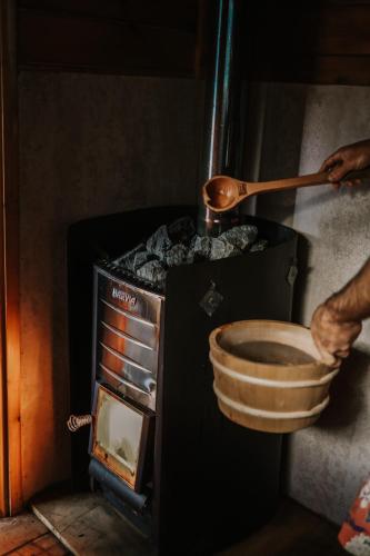 a person is putting a bowl in an oven at Premalaya in Yallingup