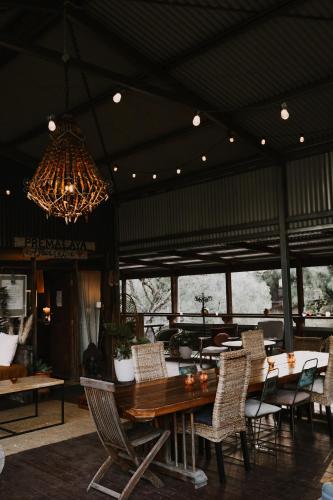 a dining room with a table and chairs and a chandelier at Premalaya in Yallingup